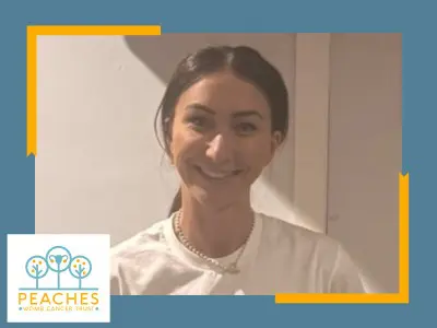 New CNS Cath - white female, brown hair tied back, wearing white t-shirt with Peaches logo