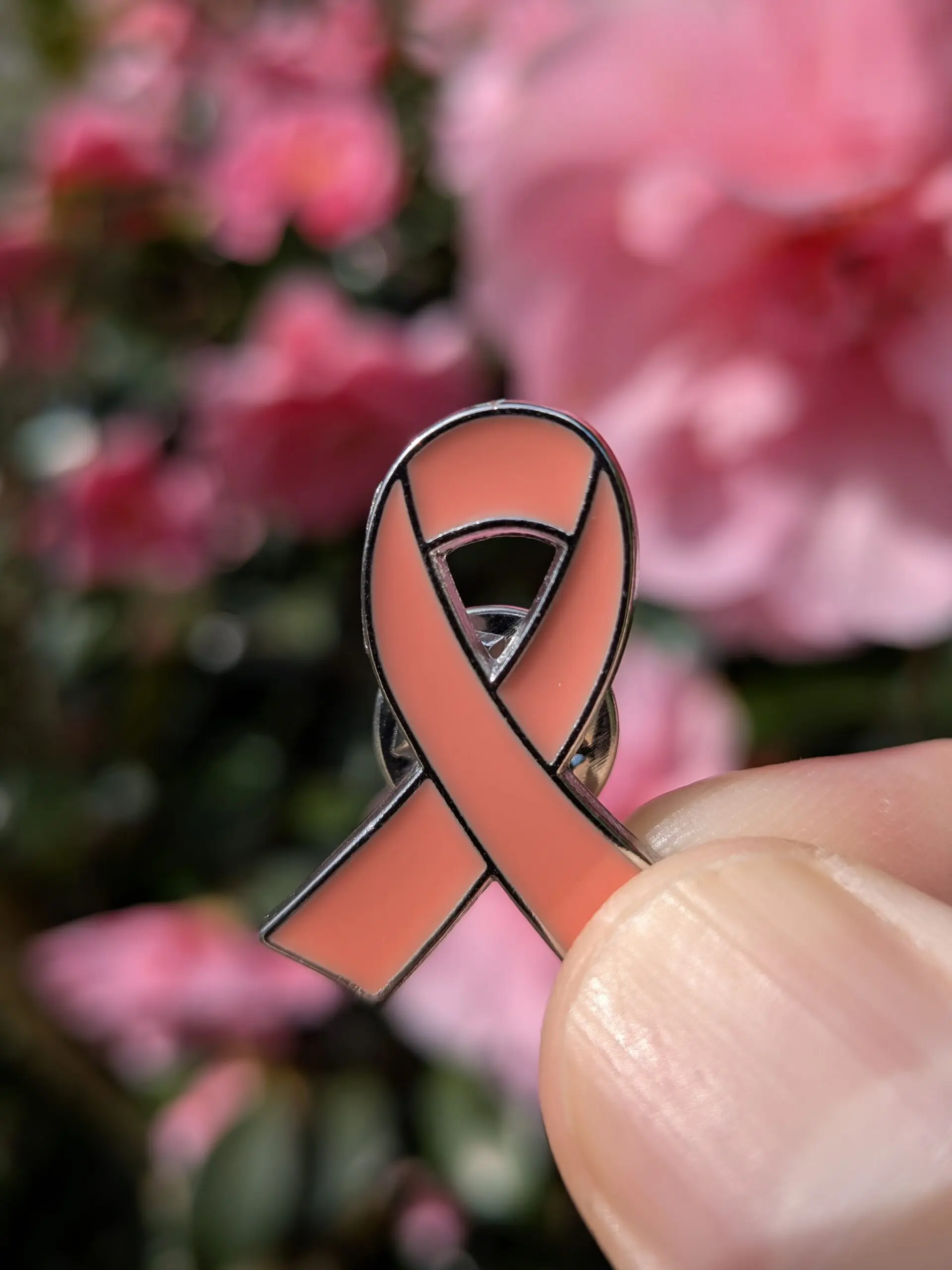 photo of peach ribbon pin badge